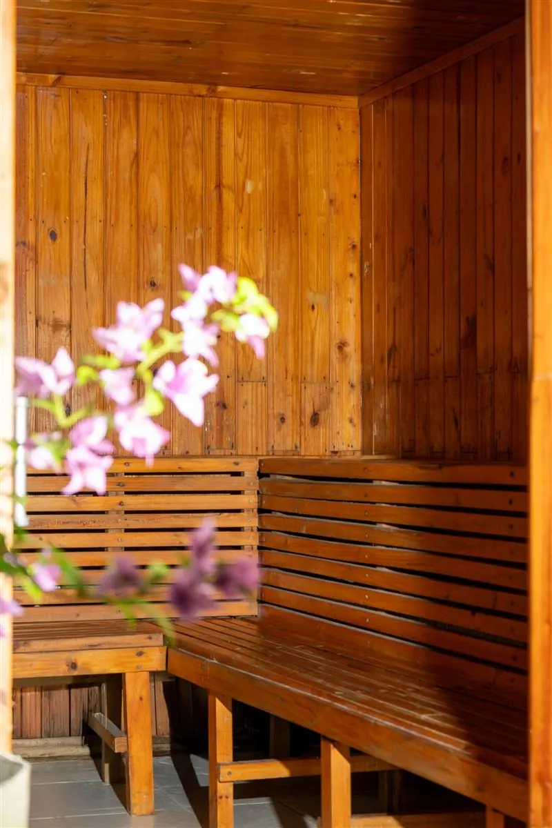 Sauna seco de madera con flores en la entrada
